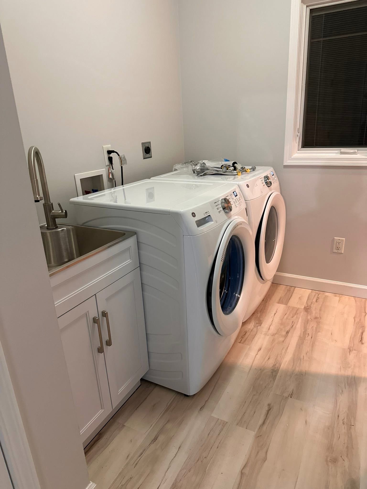 Laundry room renovation with new appliances and utility sink